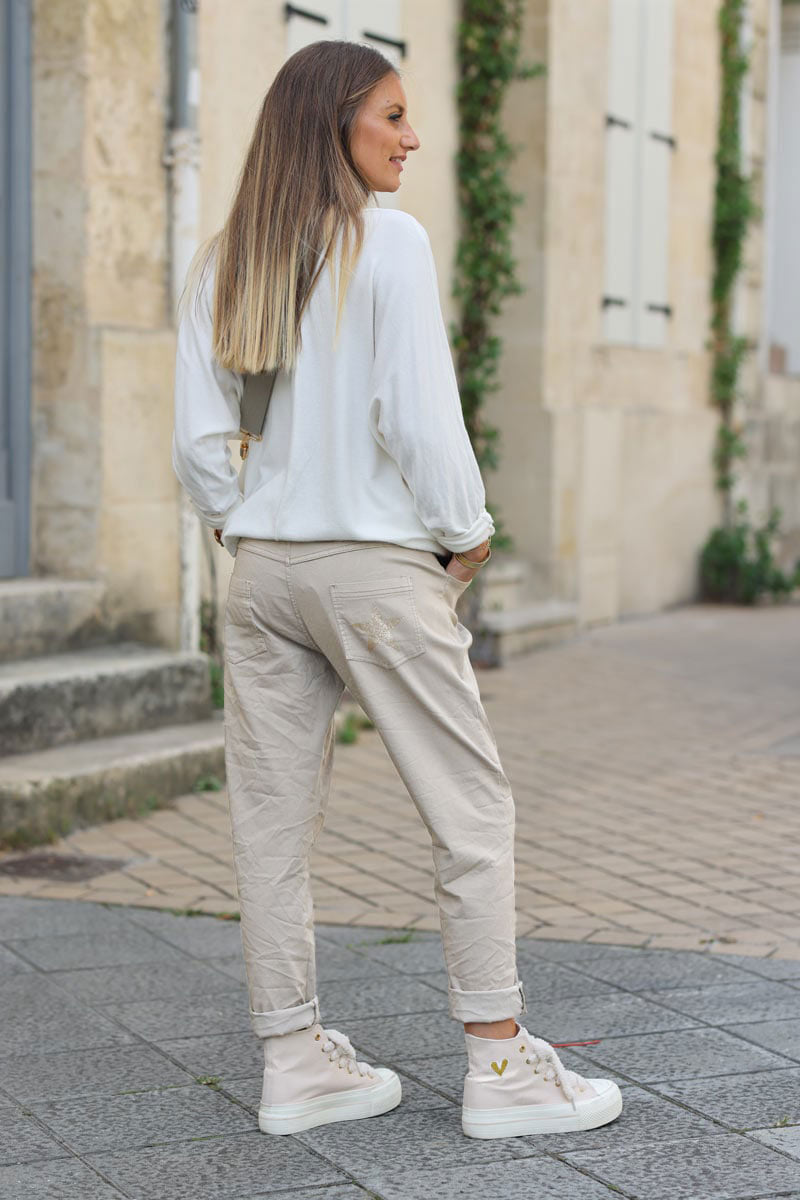 Beige comfort and stretch fabric pants with a glitter star