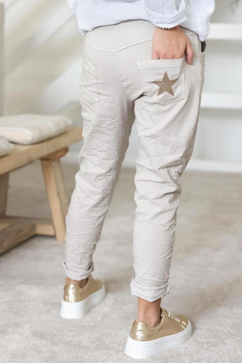 Cream comfort and stretch fabric pants with a glitter star
