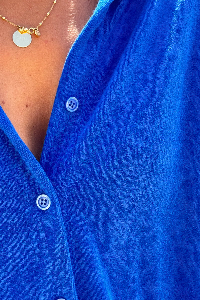 Vestido de rizo azul real con cuello camisero y botones.