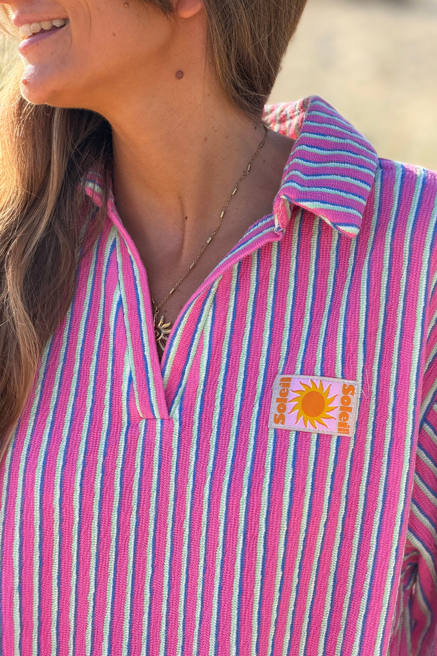 Robe polo rose en éponge à rayures pastel détails Soleil
