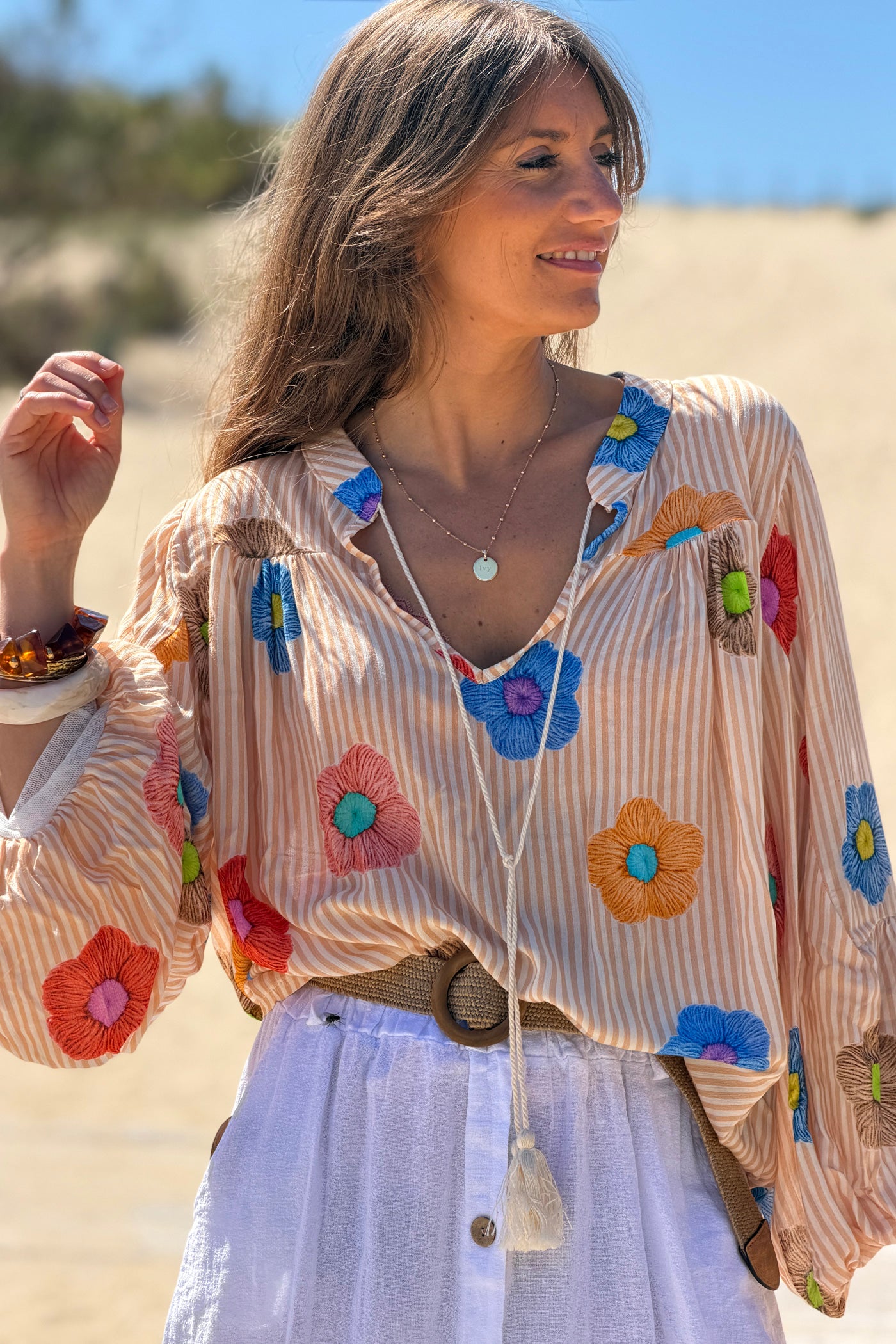 Floaty semi-sheer blouse with orange stripes and colourful flower print