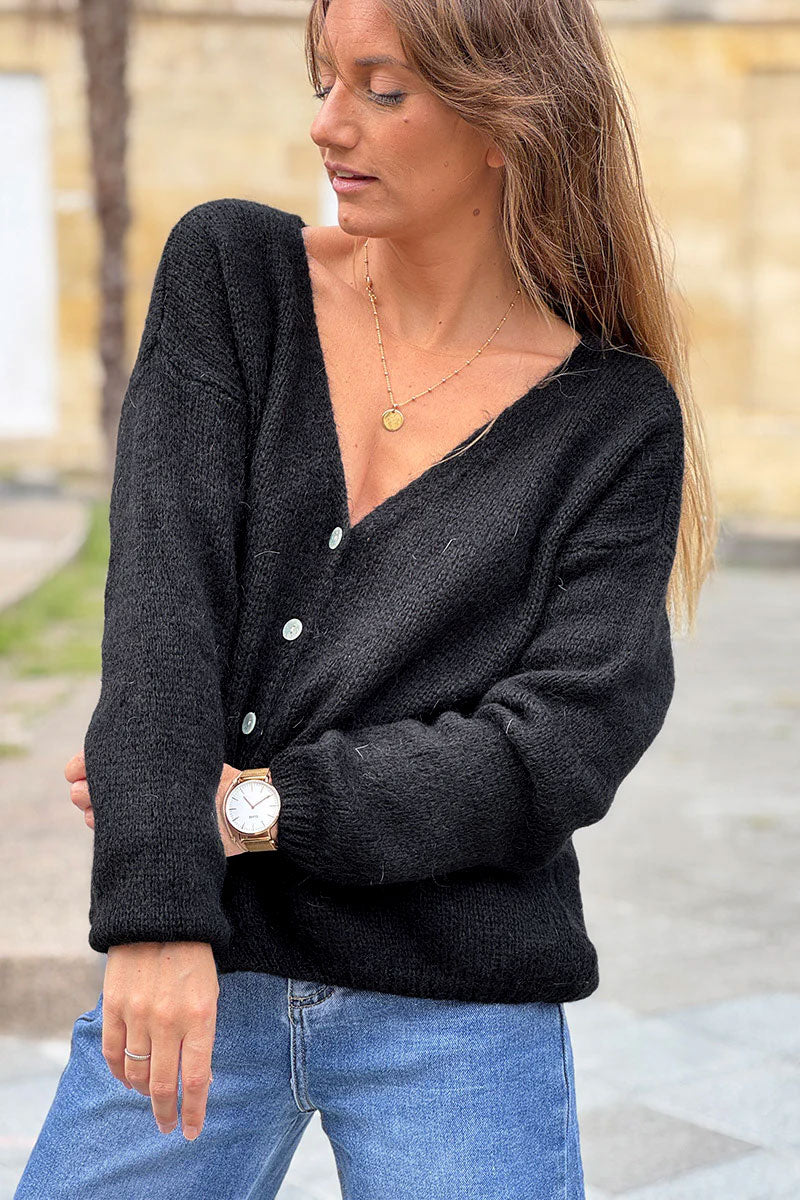 Chaleco negro liso de punto con pequeños botones de nácar
