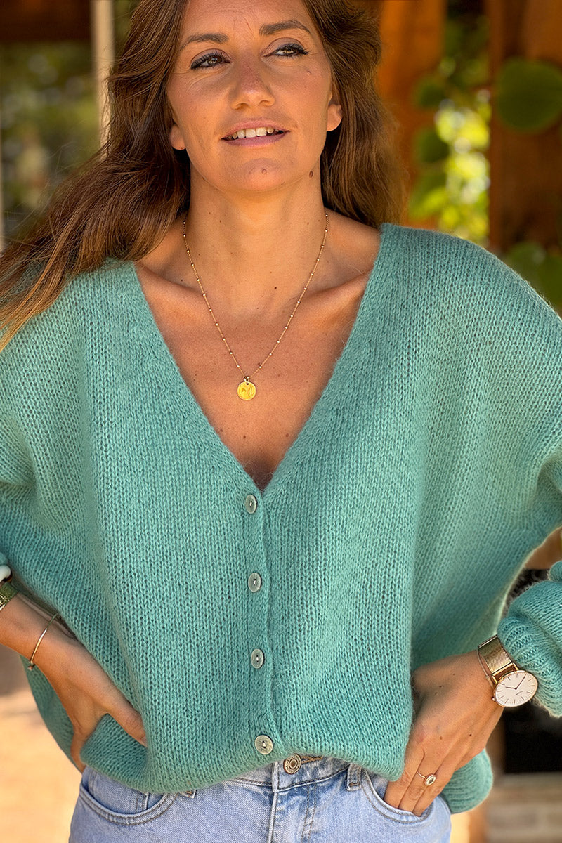 Gilet uni turquoise en maille petits boutons nacrés