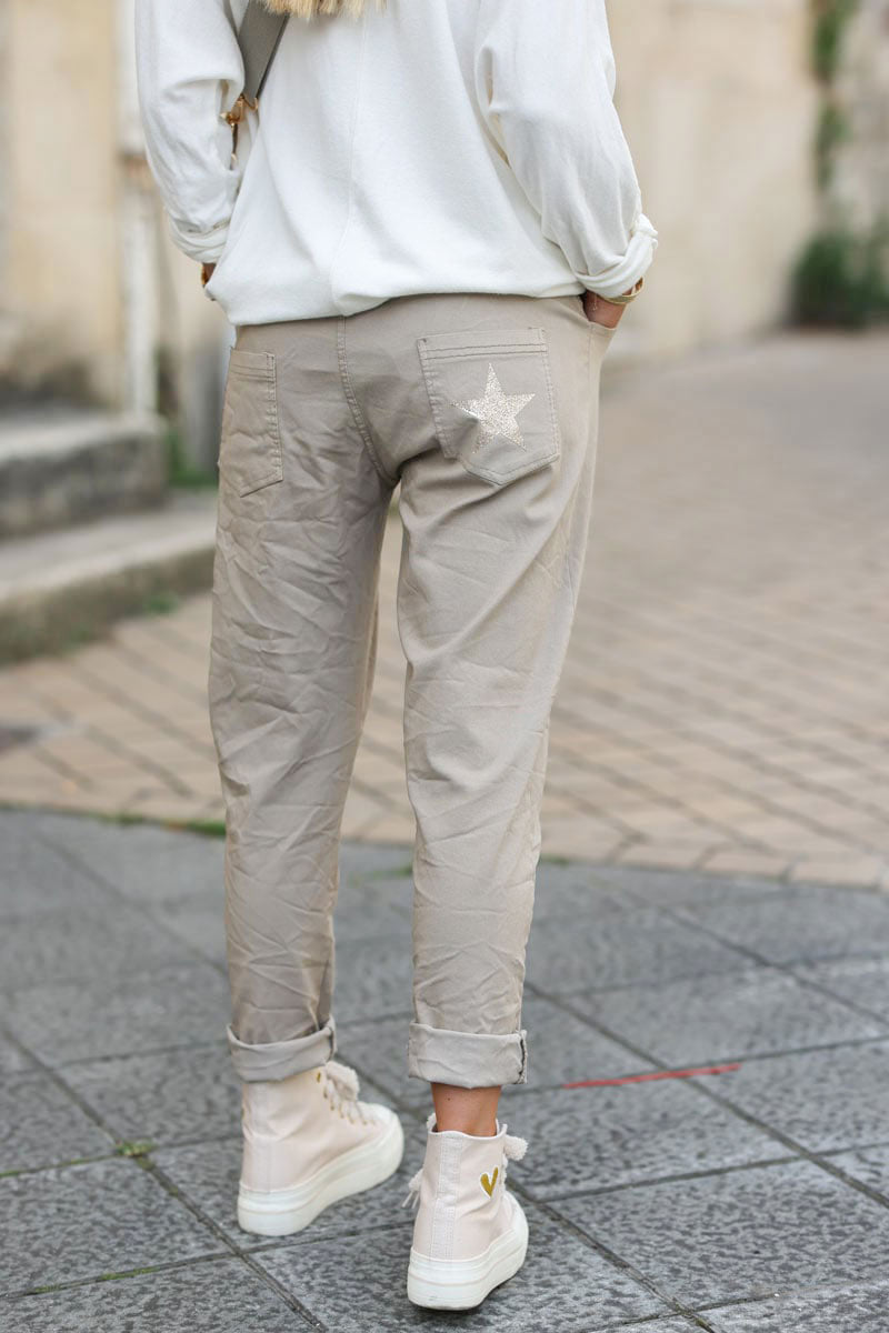 Beige comfort and stretch fabric pants with a glitter star