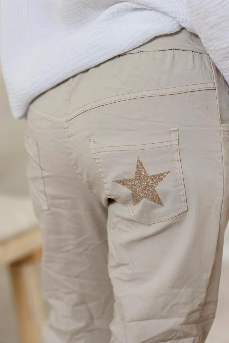 Cream comfort and stretch fabric pants with a glitter star