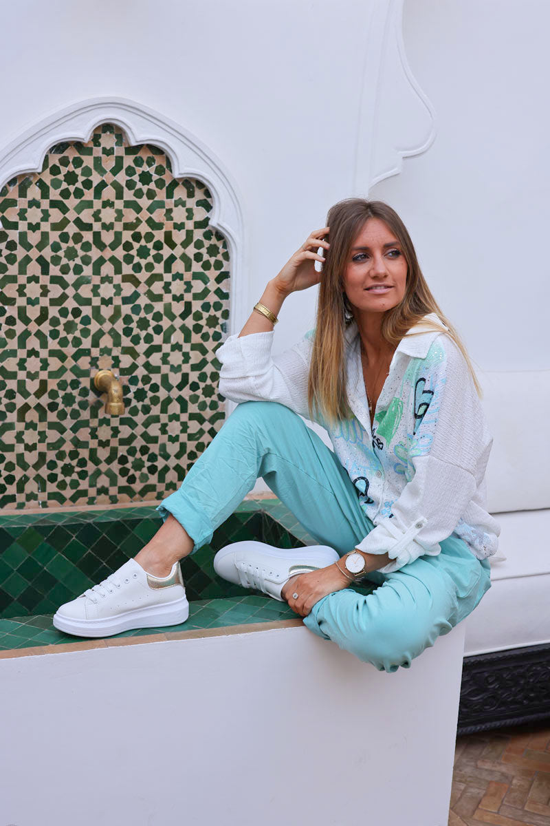 Turquoise comfort and stretch fabric pants with a glitter star