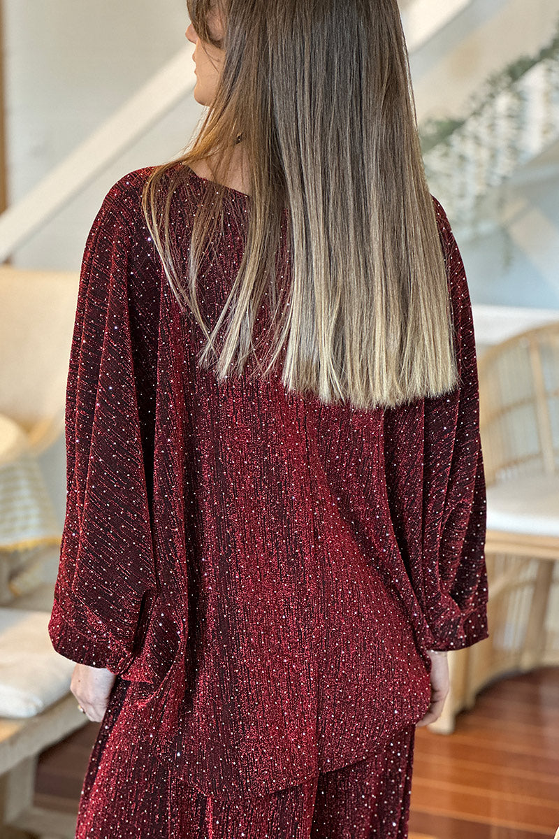 Top noir large manches chauve souris en lurex rouge avec strass pour les fêtes
