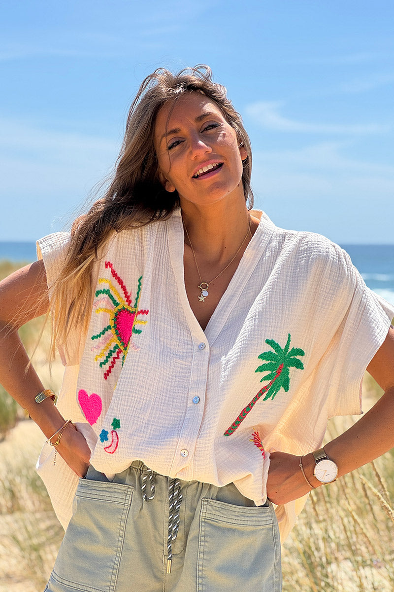 Túnica beige con botones en gasa de algodón con bordados de símbolos de verano coloridos